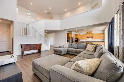a living room with a couch and a table at 1 Mi to Golf! Spacious and Modern Home in Dinuba in Dinuba