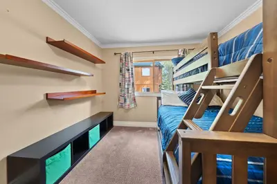 a small room with bunk beds and a tv at Cozy Aspen Haven - Stay for 6 in Truckee