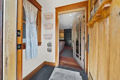 a hallway with a door leading to a bathroom at Cozy Aspen Haven - Stay for 6 in Truckee
