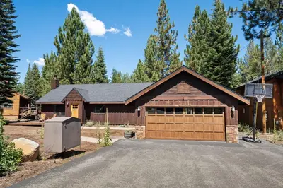 a house with a garage with a driveway at Cozy Aspen Haven - Stay for 6 in Truckee