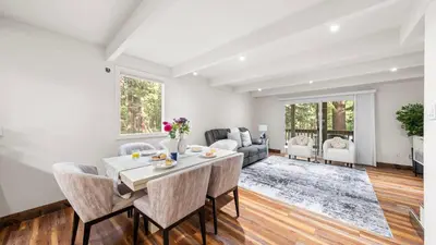 a white living room with a table and chairs at Cozy Forest Hideaway in Incline Village Private Balcony Sierra Solace by AvantStay in Incline Village