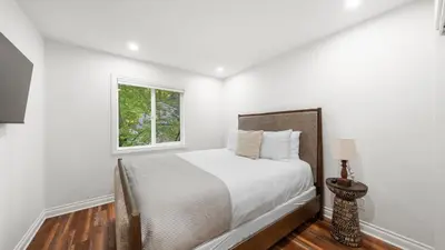 a white bedroom with a bed and a window at Cozy Forest Hideaway in Incline Village Private Balcony Sierra Solace by AvantStay in Incline Village