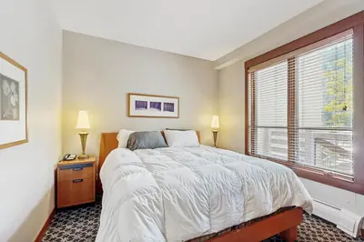 a bedroom with a large bed and a window at Ski-InandSki-Out Condo with Views in Olympic Valley in Olympic Valley