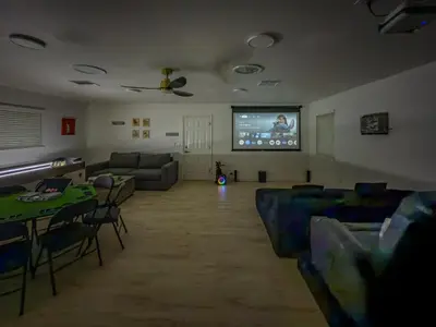 a living room with a couch and a flat screen tv at Yosemite Luxe Family Lodge - Spa, Theater, Sauna, EV, Game Room, Poker Table in Mariposa