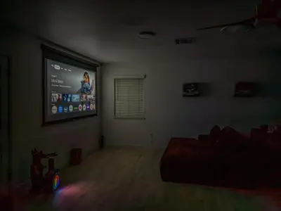 a living room with a large projection screen on the wall at Yosemite Luxe Family Lodge - Spa, Theater, Sauna, EV, Game Room, Poker Table in Mariposa