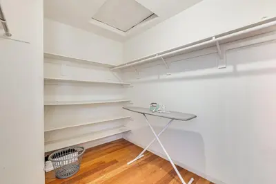 a room with white shelves and a table in it at Rudraksha-5BR Luxury,3Bath, NE Fresno, Shopping, Dining, Medical, Tourist Attractions in Fresno