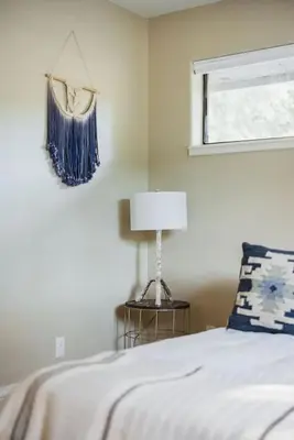 a bedroom with a bed with a lamp and a window at 7BR 3Bath in Yosemite & Bass Lake with BBQ & Hot Tub in Oakhurst