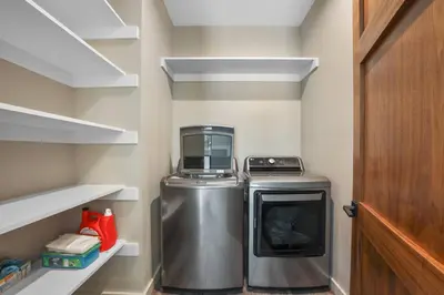 a small laundry room with a washer and dryer at Song of the Sierras - 4 Bed, 4 Bath Luxury Tahoe Home in South Lake Tahoe