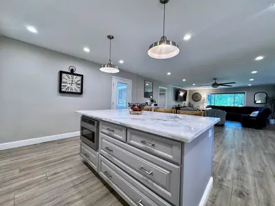 a kitchen with a large island in a living room at Peaceful Country Getaway Near Casino Shopping in Placerville