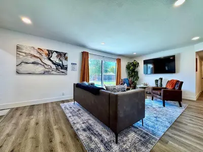 a living room with a couch and a tv at Pool Remodeled 4 Bedroom Carmichael Home in Carmichael