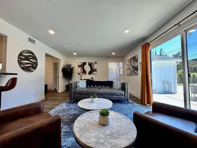 a living room with a couch and a table at Pool Remodeled 4 Bedroom Carmichael Home in Carmichael