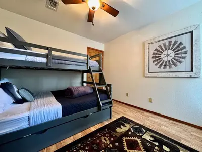 a bedroom with two bunk beds and a ceiling fan at Forest View Family Home in Pollock Pines
