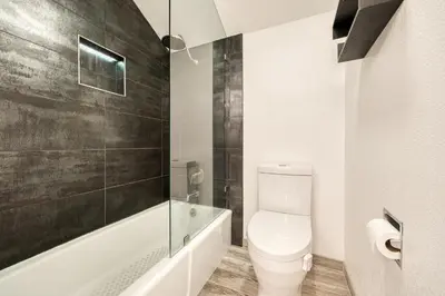 a bathroom with a toilet and a tub and a sink at River Run # 15 by Tahoe Getaways - 2 BR w Private Balcony, River Views & Shuttle in Alpine Meadows