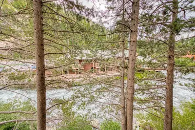 a view of a river through the trees at River Run # 15 by Tahoe Getaways - 2 BR w Private Balcony, River Views & Shuttle in Alpine Meadows