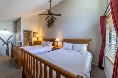 two beds in a bedroom with two lamps and a window at Walk to Village, 1+L/2BA; Jacuzzi, Parking, W/D in Mammoth Lakes