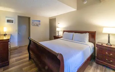 a bedroom with a large bed and two night stands at Walk to Village, 1+L/2BA; Jacuzzi, Parking, W/D in Mammoth Lakes