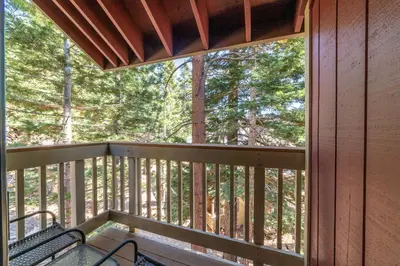 a screened in porch with a bench on the deck at Walk to Village, 1+L/2BA; Jacuzzi, Parking, W/D in Mammoth Lakes