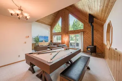 a room with a pool table and a fireplace at Hearthlight Cabin at Tahoe Donner by Tahoe Getaways - Pet-Friendly 3BR w Guest Suite in Truckee