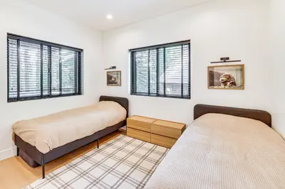 two beds in a room with windows at 4 Mi to Soda Springs Resort Hot Tub Hideaway! in Soda Springs