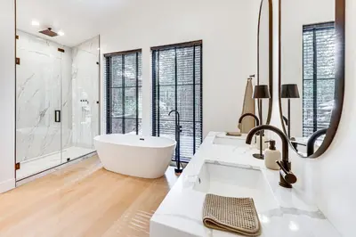 a white bathroom with two sinks and a tub at 4 Mi to Soda Springs Resort Hot Tub Hideaway! in Soda Springs
