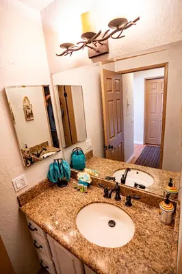 a bathroom with a sink and a large mirror at Amazing Gem Next to golf course with View- Pool & jacuzzi in Mammoth Lakes