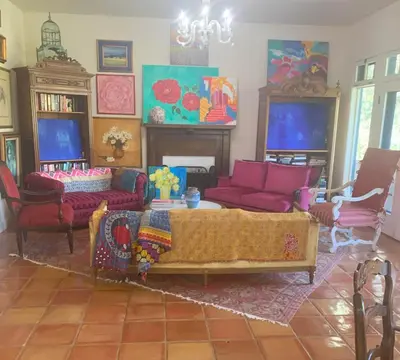 a living room with a couch and a table and chairs at Heidi's Artistic Abode in Three Rivers