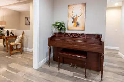 a brown piano in a room with a painting on the wall at Historic Mountain Retreat - Near Boreal - 3 Kings in Emigrant Gap