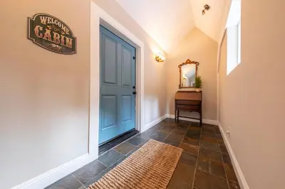 a hallway with a blue door and a mirror at Historic Mountain Retreat - Near Boreal - 3 Kings in Emigrant Gap