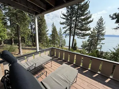 a balcony with chairs and a view of the water at Lake Tahoe Cabin I Hammocks, Paddle Boards and Bikes in Homewood