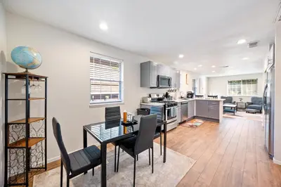 a kitchen and living room with a table and chairs at Cozy Nest Across the street from UC Davis Sacramento in Sacramento