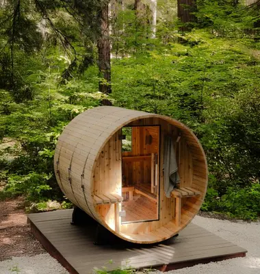 a small wooden circular house in a forest at A-Frame Cabin - Sauna, Hot Tub, Fire Pit, Projector in Arnold