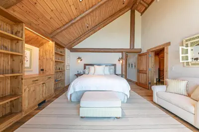 a bedroom with a bed and a couch at Beyond the Blue Lakefront Escape by Tahoe Getaways - Pet-Friendly 6BR with Pier, Buoy & Hot Tub in Carnelian Bay