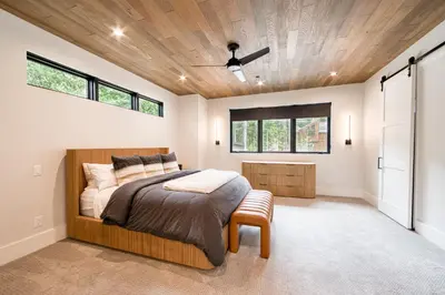 a bedroom with a bed and a ceiling with windows at Shining Creek at Alpine Meadows by Tahoe Getaways - 4 BR w Creek Views, Hot Tub & Ski Shuttle! in Alpine Meadows