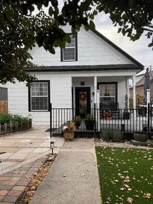 a white house with a black fence at Historic 1914 Cottage, Near Downtown, UNR & Hospitals, Early Check In in Reno