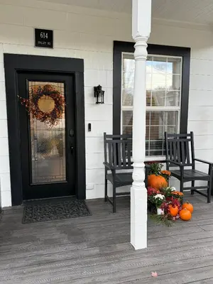 a porch with two chairs and a door with a wreath at Historic 1914 Cottage, Near Downtown, UNR & Hospitals, Early Check In in Reno