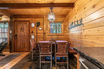 a dining room with a table and chairs at Classic Cabin in the Pines by Tahoe Getaways - Walk to Lake, Pet-Friendly 3 BR w Yard & Hot Tub! in Homewood