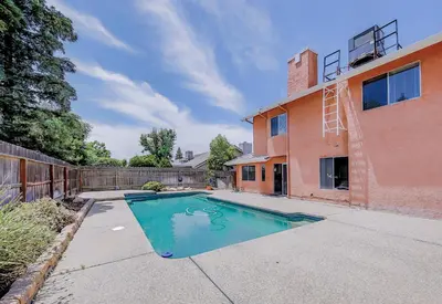 a swimming pool in front of a house at Cozy Room#1 Best Moscato in Clovis