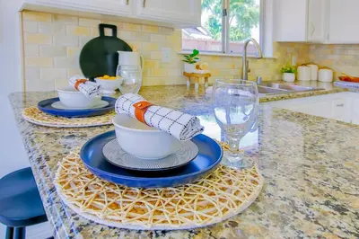 a kitchen counter with plates and cups and a sink at Cozy Room#1 Best Moscato in Clovis