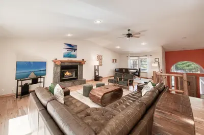 a living room with a couch and a fireplace at Emerald Lodge at Tahoe Park by Tahoe Getaways - 4BR w HOA Beach & Air Conditioning in Tahoe City