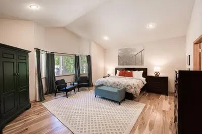a bedroom with a bed and a green door at Emerald Lodge at Tahoe Park by Tahoe Getaways - 4BR w HOA Beach & Air Conditioning in Tahoe City