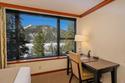 a room with a desk and a window with a mountain view at Olympic Valley Studio Condo with Resort Pools, Spa in Olympic Valley