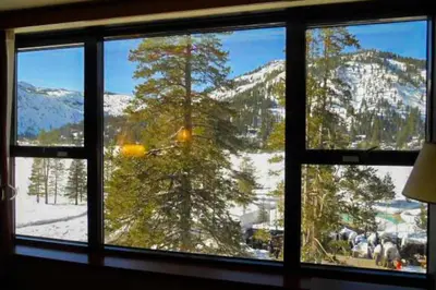 a window with a view of a snow covered mountain at Olympic Valley Studio Condo with Resort Pools, Spa in Olympic Valley