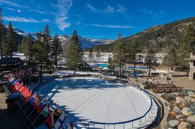 an ice skating rink with flags on a ski slope at Olympic Valley Studio Condo with Resort Pools, Spa in Olympic Valley