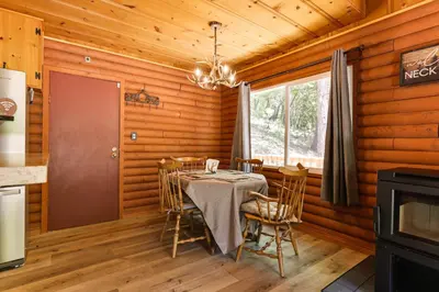 a dining room with a table and chairs and a window at Community Lake Access Peaceful Cabin in Sonora! in Sonora