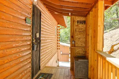 an entrance to a cabin with a wooden door at Community Lake Access Peaceful Cabin in Sonora! in Sonora