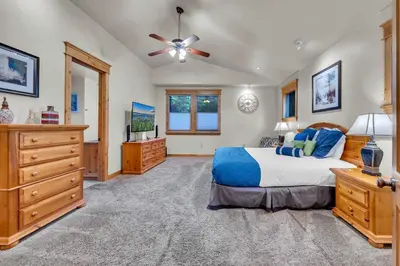 a bedroom with a bed and a ceiling fan at Tahoe Island Retreat Hot Tub & Game Room in South Lake Tahoe