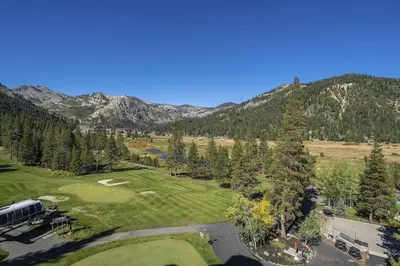 an aerial view of a golf course in the mountains at Community Perks! Everline Resort and Spa Retreat in Olympic Valley