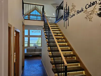 a staircase in a house with a living room at Cedar Rock Cabin in Mi-Wuk Village