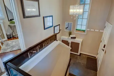a living room with a staircase and a chandelier at Historic Stone House-Reno-UNR-Family in Reno