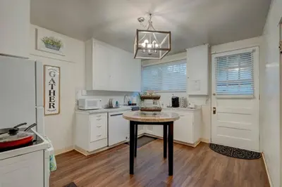a kitchen with a table in the middle of it at Historic Stone House-Reno-UNR-Family in Reno
